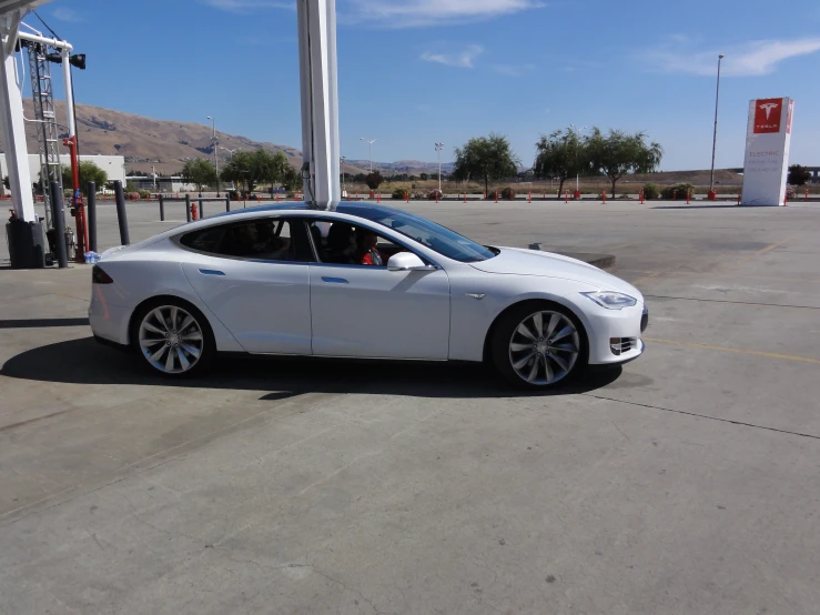 an electric car is parked at the gas station