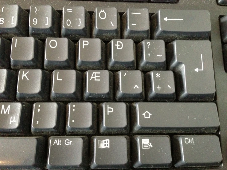 a black keyboard sitting on top of a desk