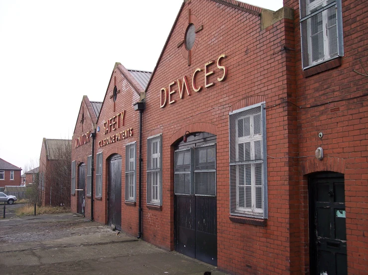 red brick building with black shutters sitting on the corner