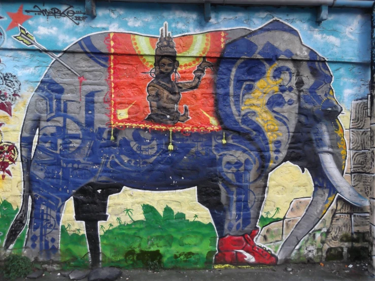 a painted mural with a man on an elephant