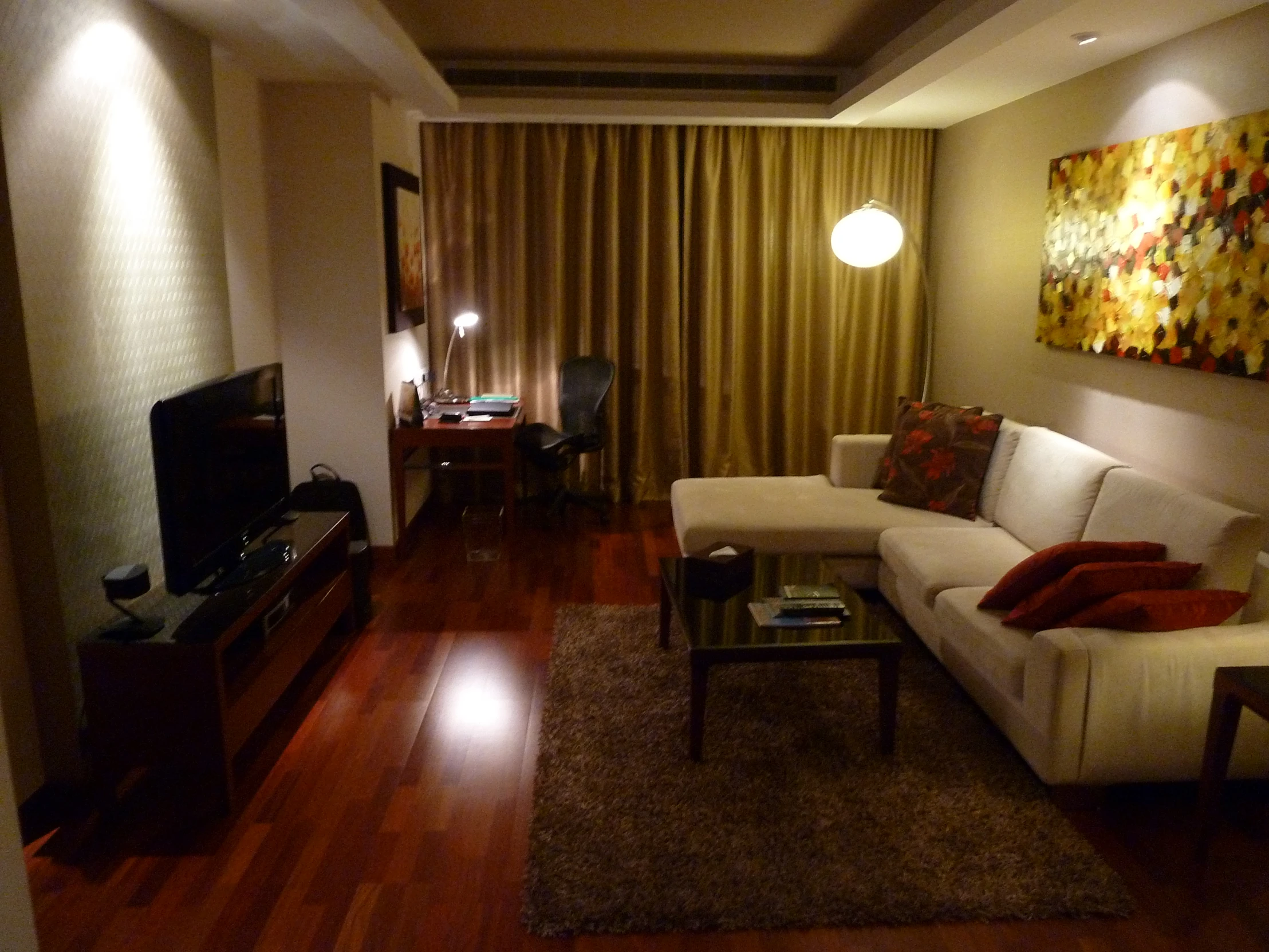 a dimly lit living room with hardwood floors