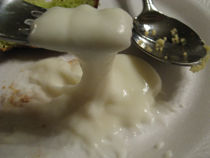 a spoon sitting on top of a plate filled with food