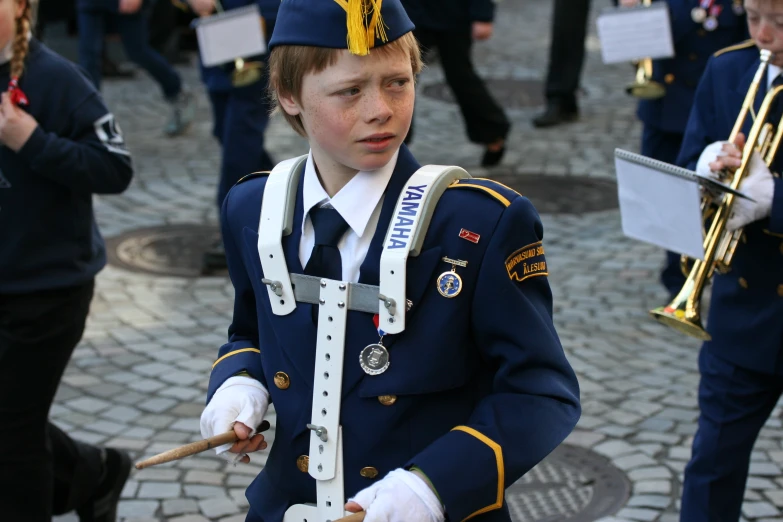 a  dressed in blue holding musical instrument