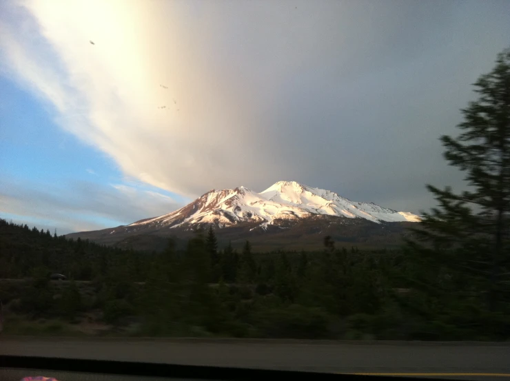 the view from a car window of snow capped mountain