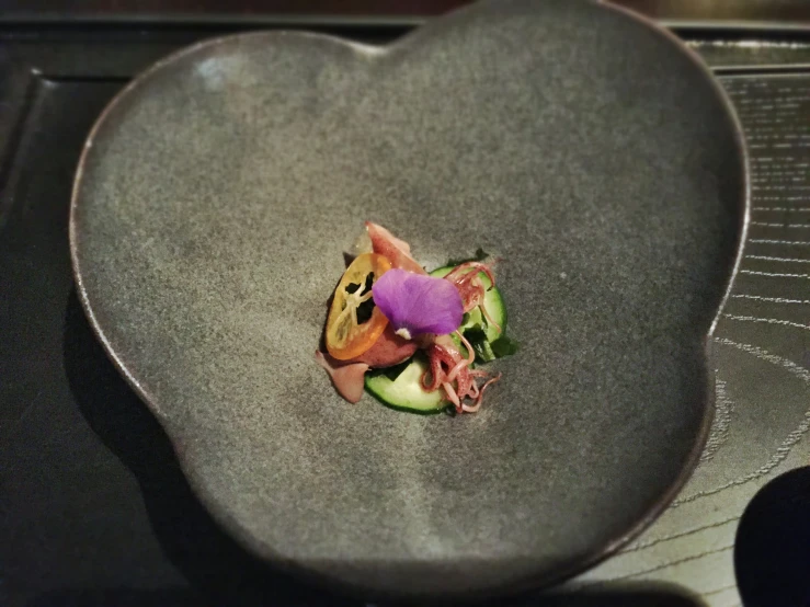 a heart shaped bowl with a food on top