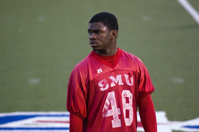 a man in a red shirt on a field