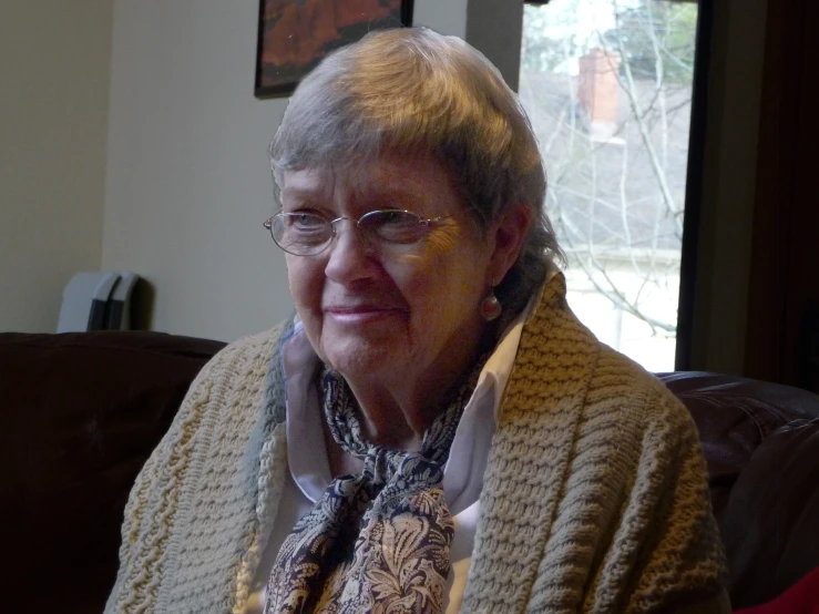 a elderly woman with glasses and a sweater