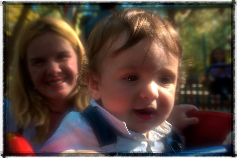 two women and one baby wearing a blue shirt