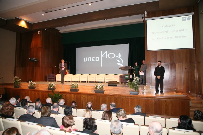 a large auditorium with an audience of people