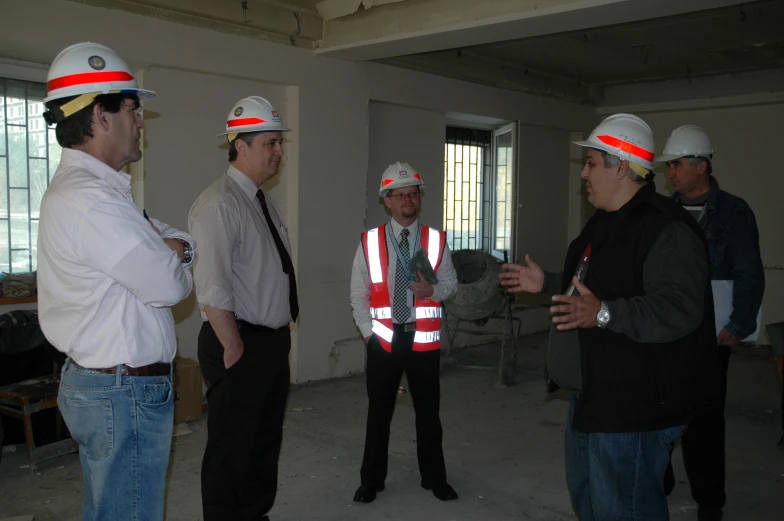 a group of people wearing safety vests and hard hats