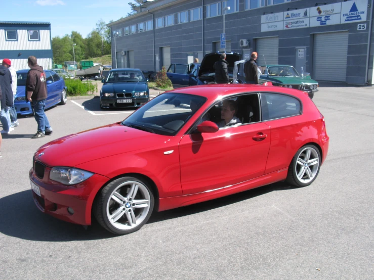 a red car with two doors and no hood on