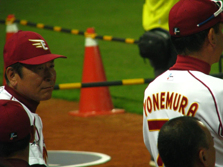 a couple of baseball players standing next to each other