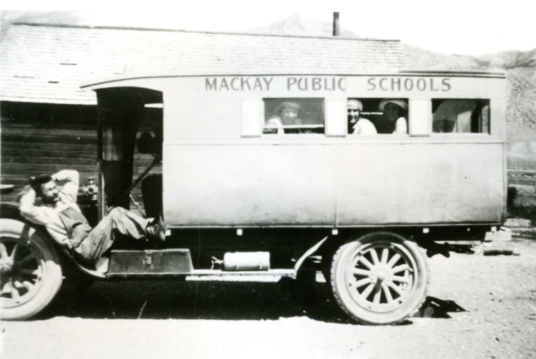 a man sitting in the passenger side door of a truck