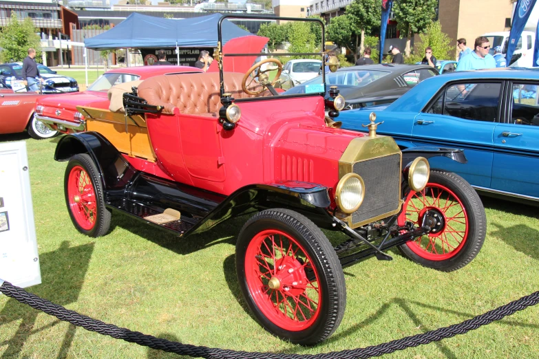 an old model ford in a display with other vintage cars