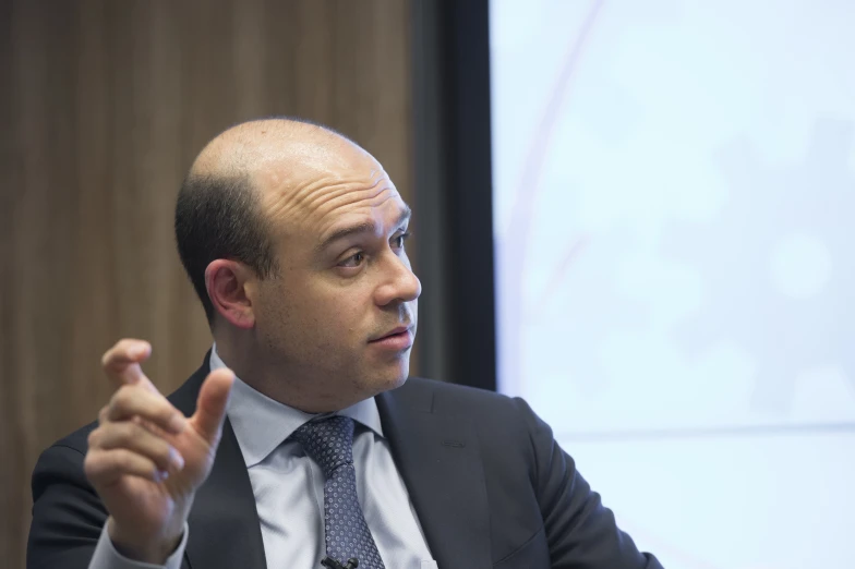 a man speaking to an audience from behind a podium