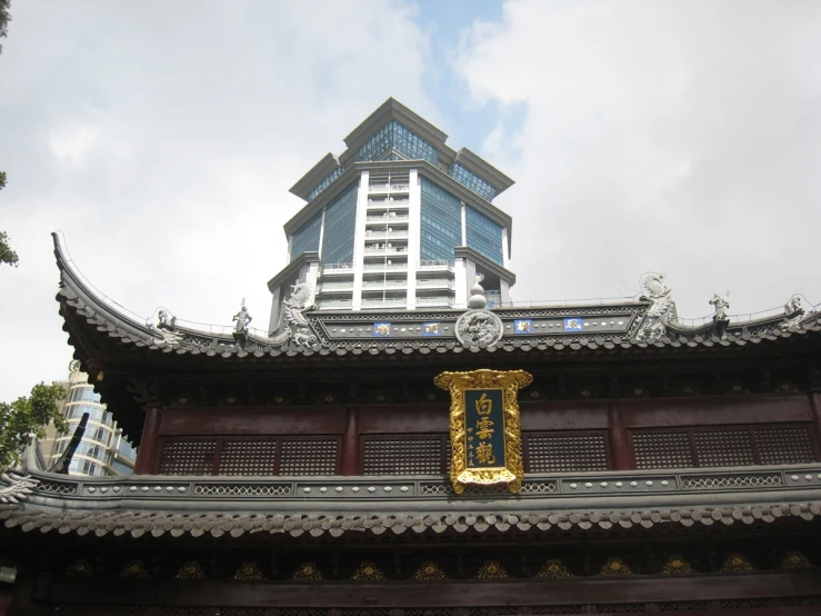 the building is made of metal with a roof with asian decoration