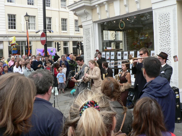 an image of group of people gathered together in the street