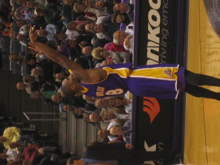 a man with a basketball on his hands standing on a court