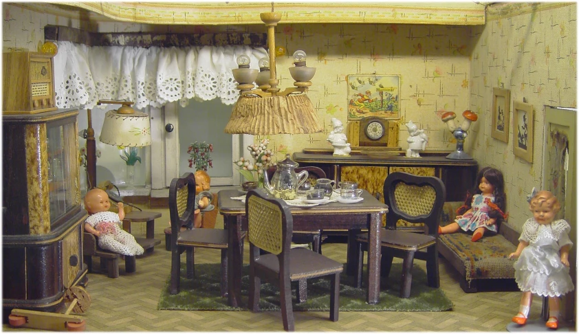 a miniature family sits in their dollhouse in a room