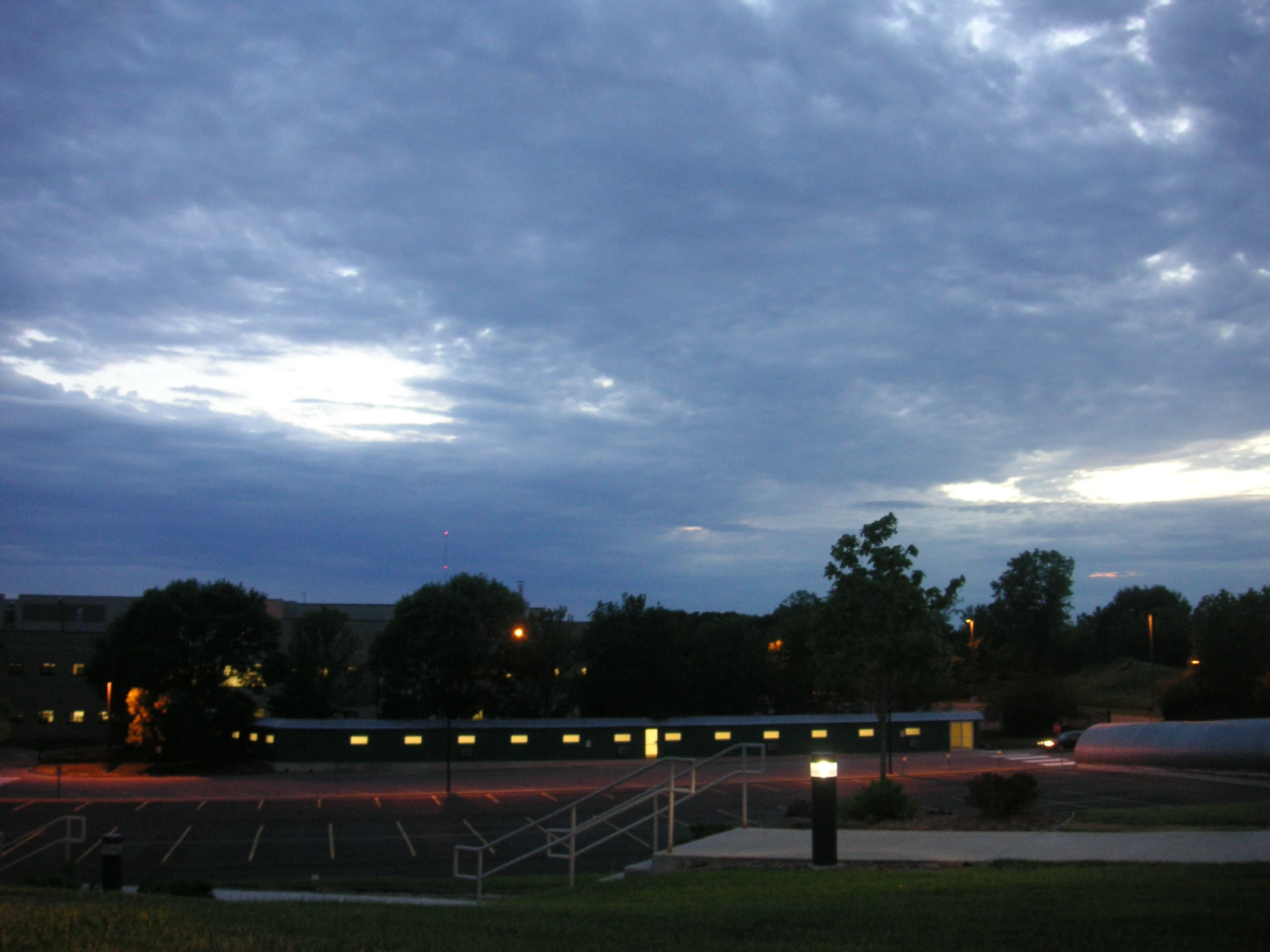 a dark, cloudy day outside on an open parking lot