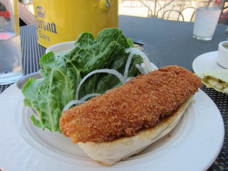 the plate has a sandwich on it and some salad on the side