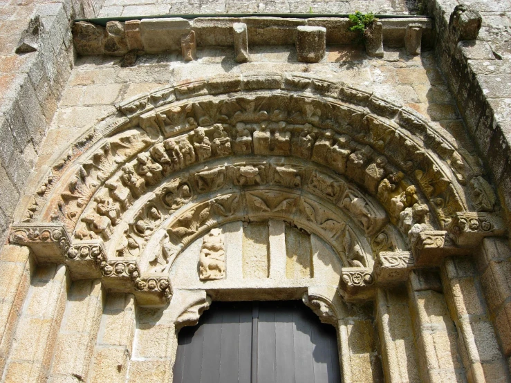 the old door to an old church has carvings on it
