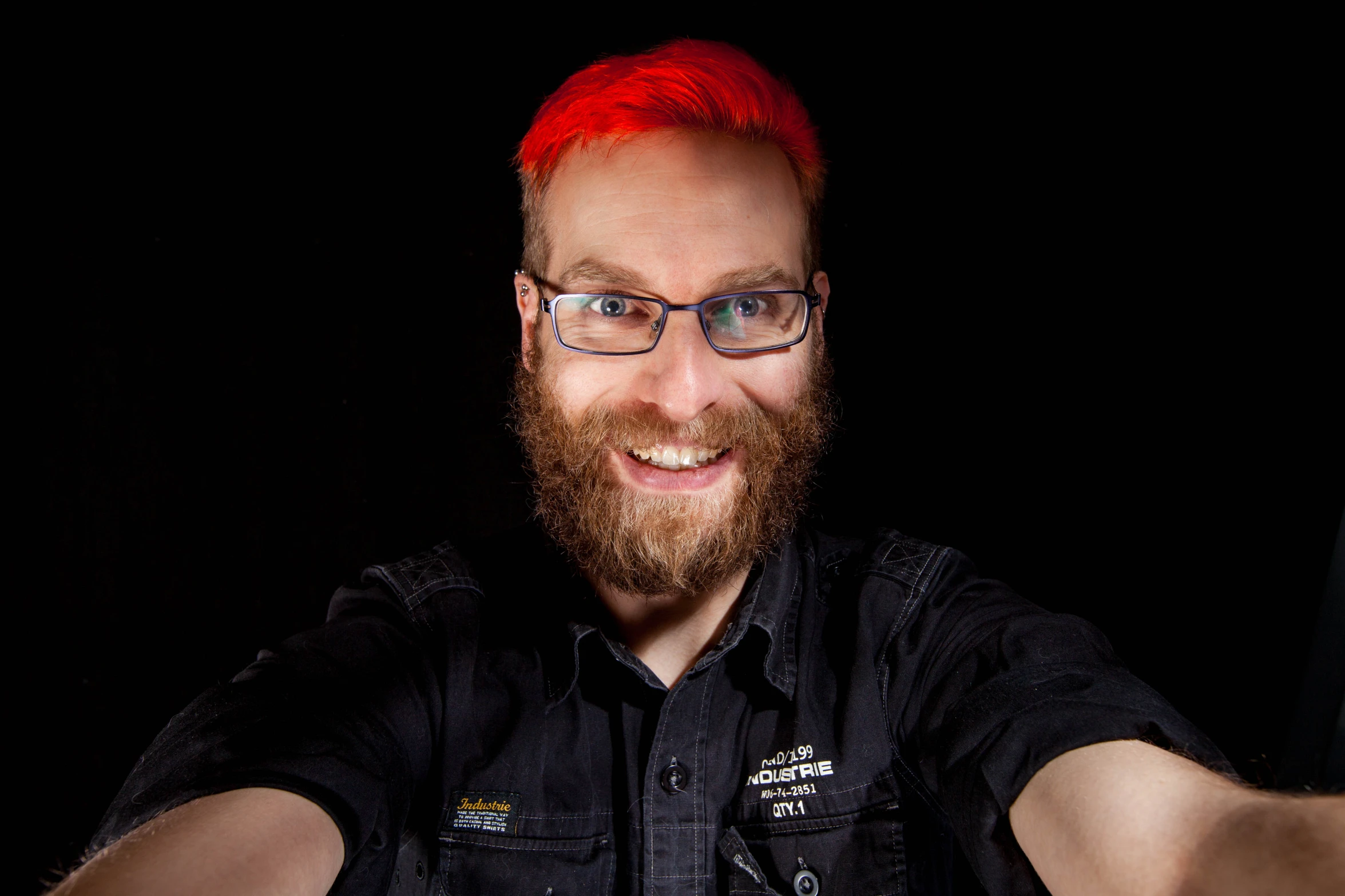 a close up of a person with a red hair and glasses