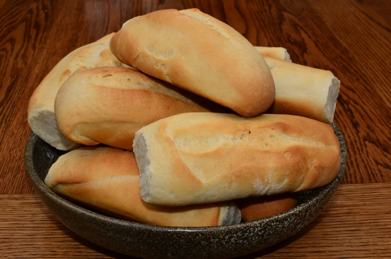 round slices of bread are sitting in a small bowl