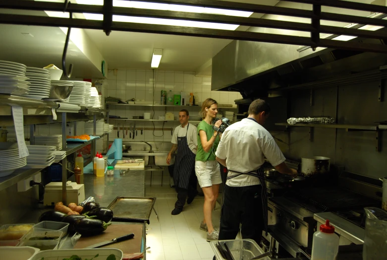 four people in a kitchen working on food