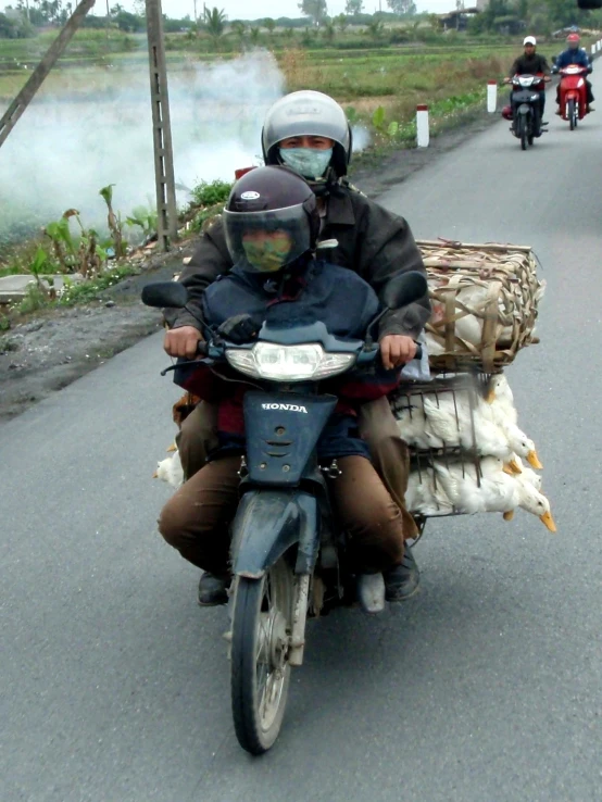 a man on a motorcycle is carrying a basket