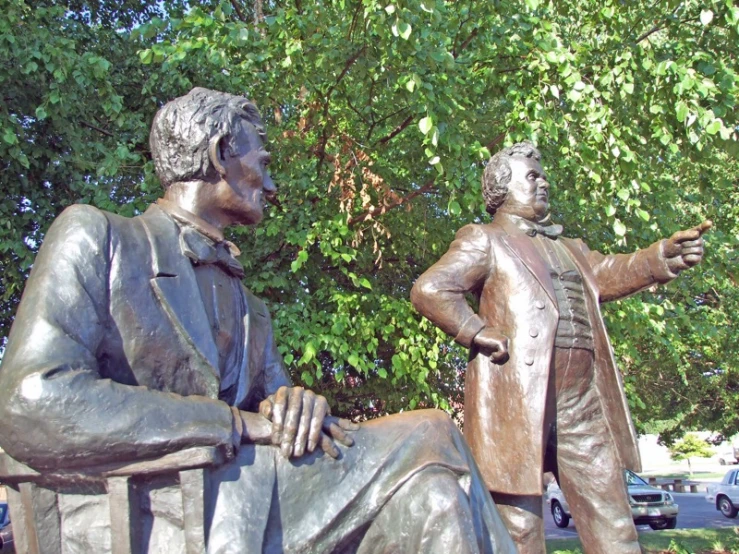 the statue depicts two men in different costumes
