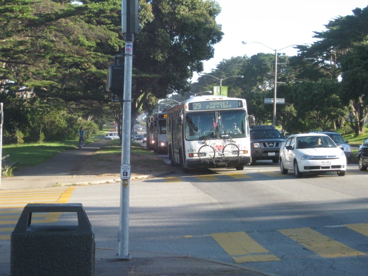 a white city bus turning on an empty street