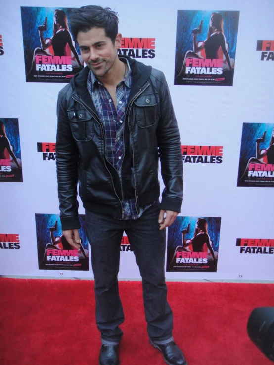 a person on a red carpet and a man in a black jacket