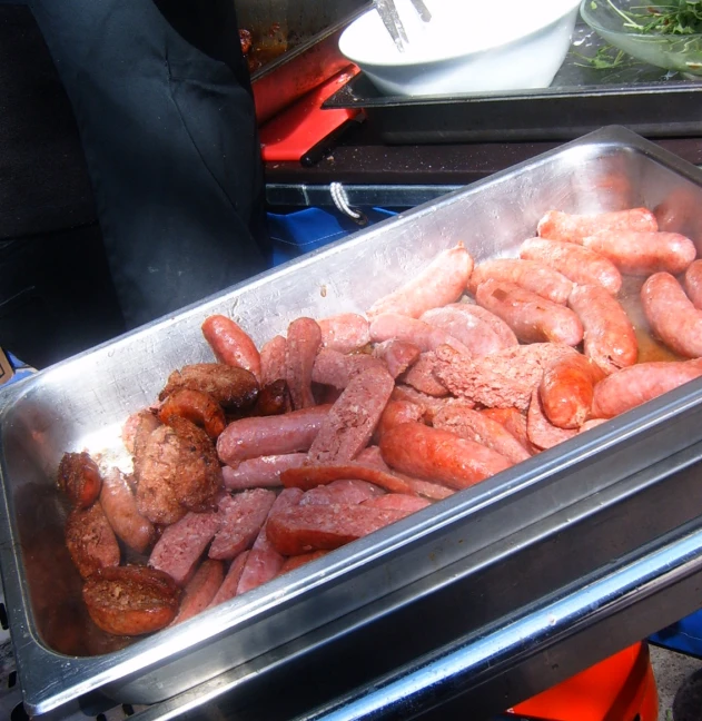 a pile of sausages is shown in an insulated serving pan