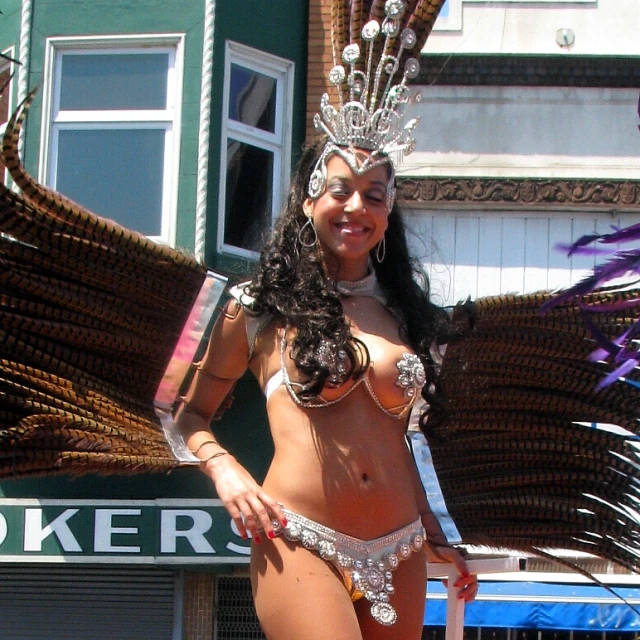 a woman in a bikini top and a large skirt on a street