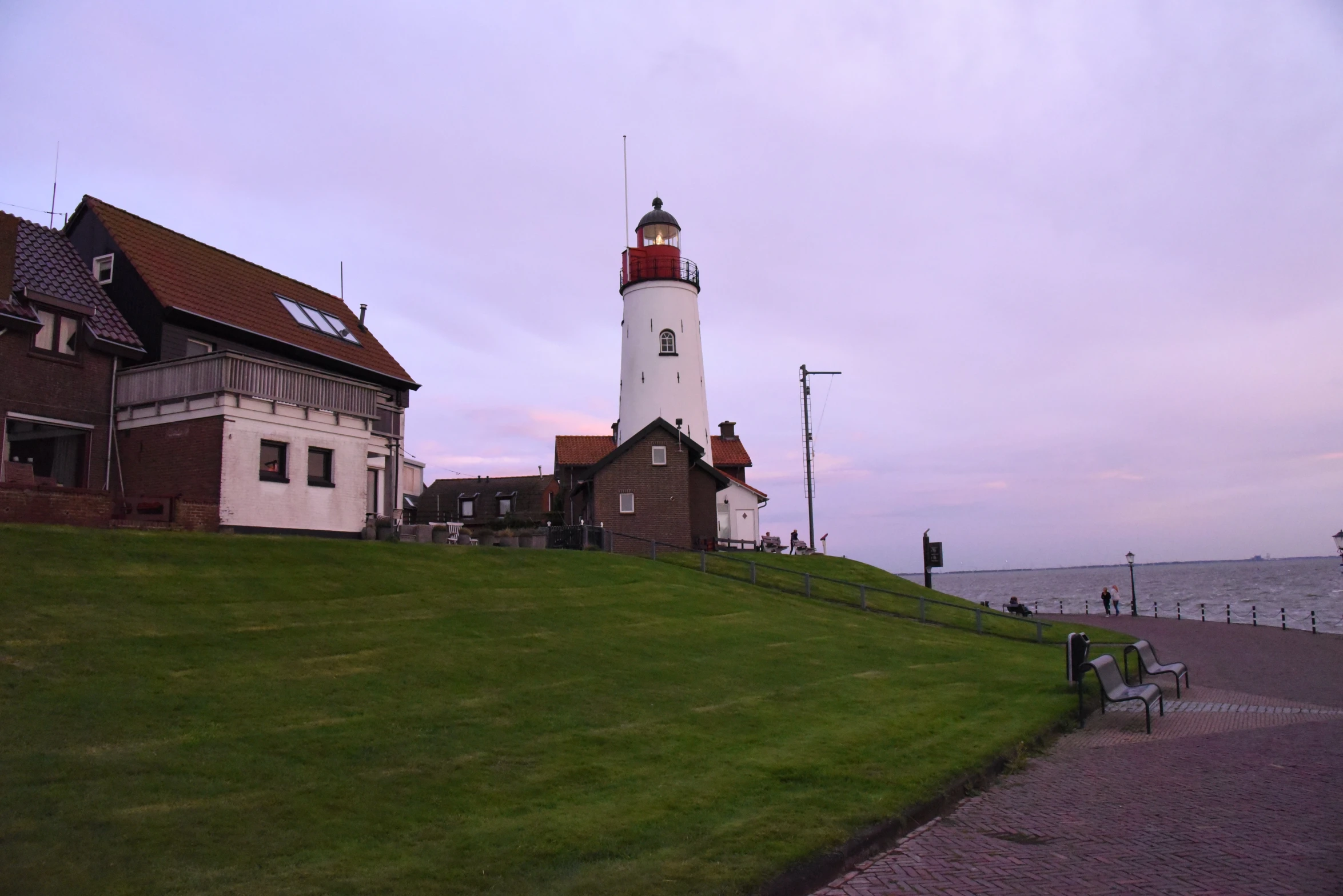 a lighthouse on the shore of a body of water