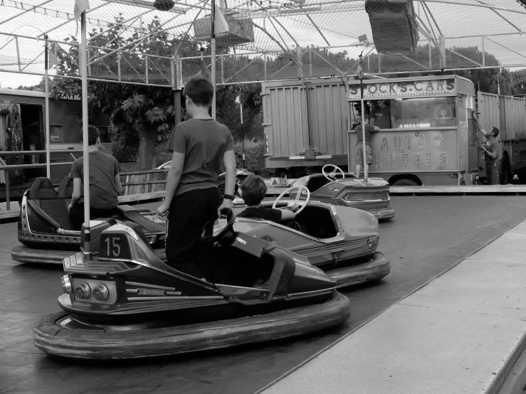 people riding on bumper cars in an outdoor fair