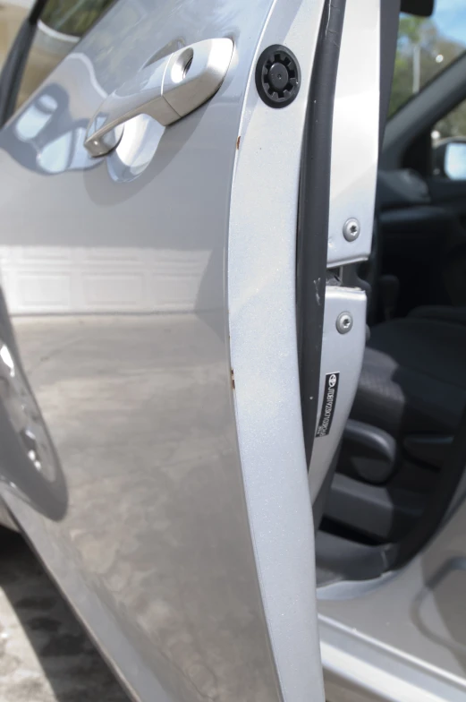 the inside door handle of a silver car