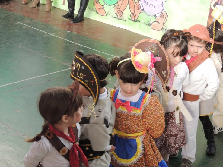 small children in costume standing on a stage