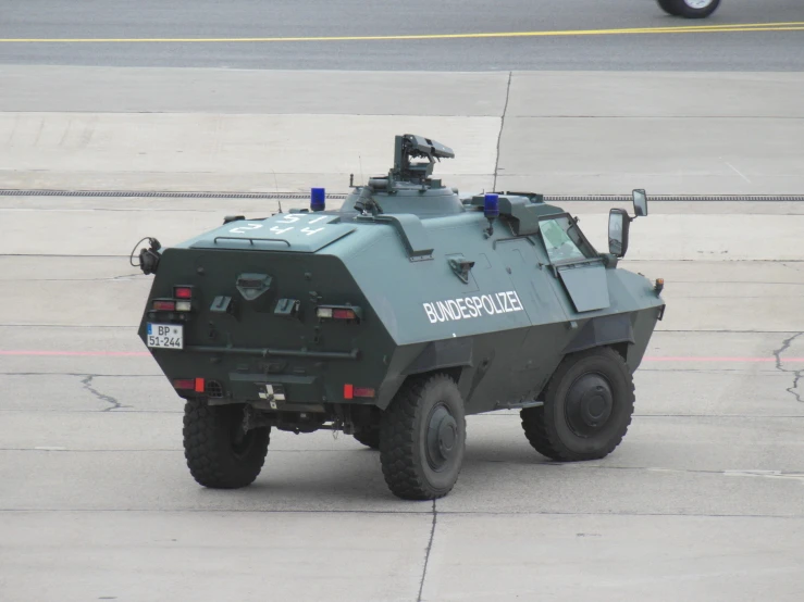 there is a green military vehicle on the runway