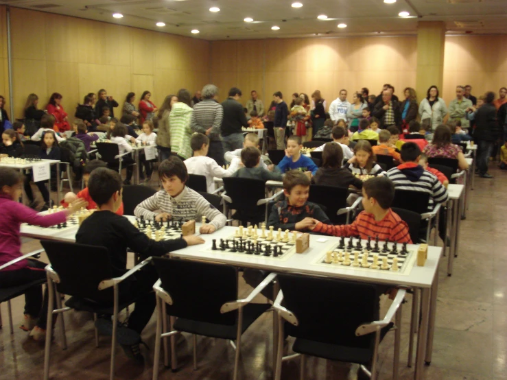 people in a ballroom playing a game of chess