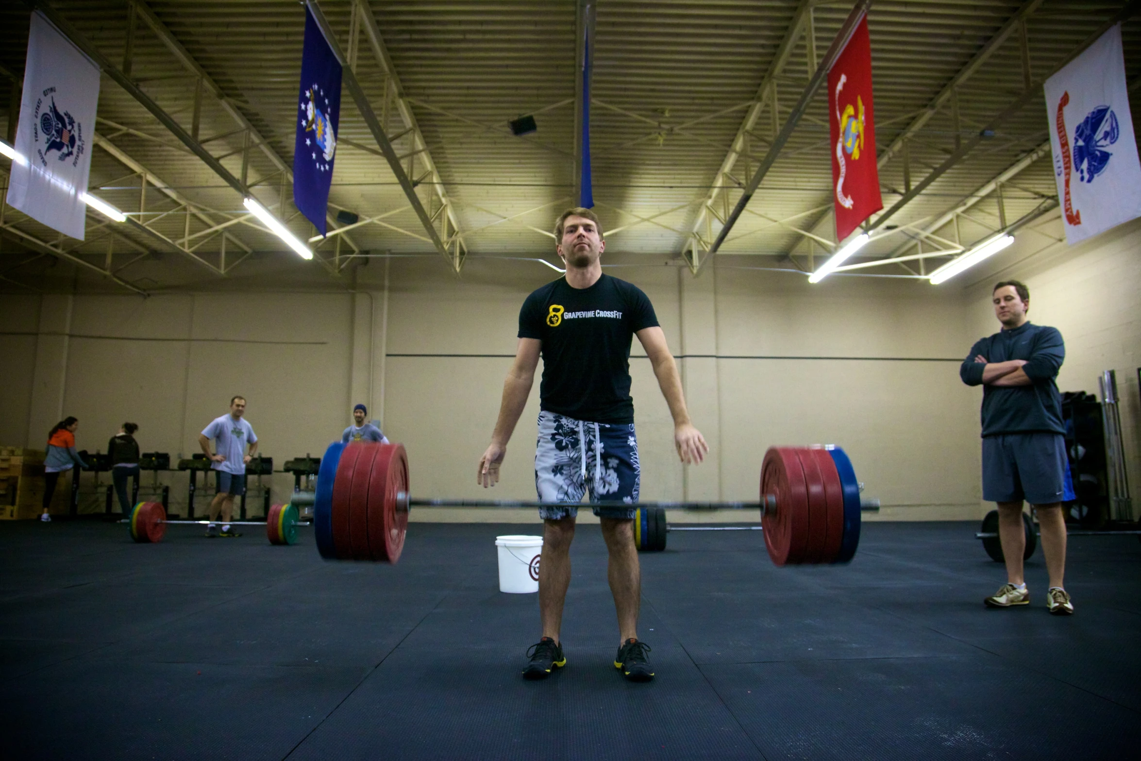 a man lifting three olympic weights with both hands