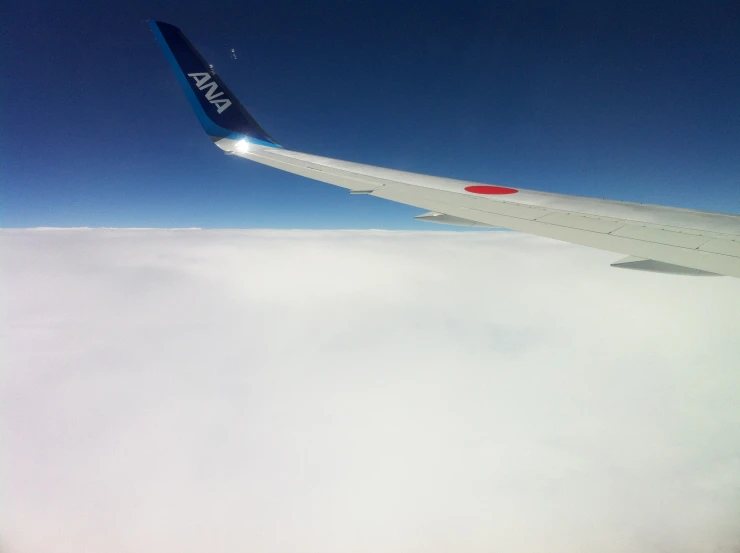 a wing from an airplane that is flying high in the sky