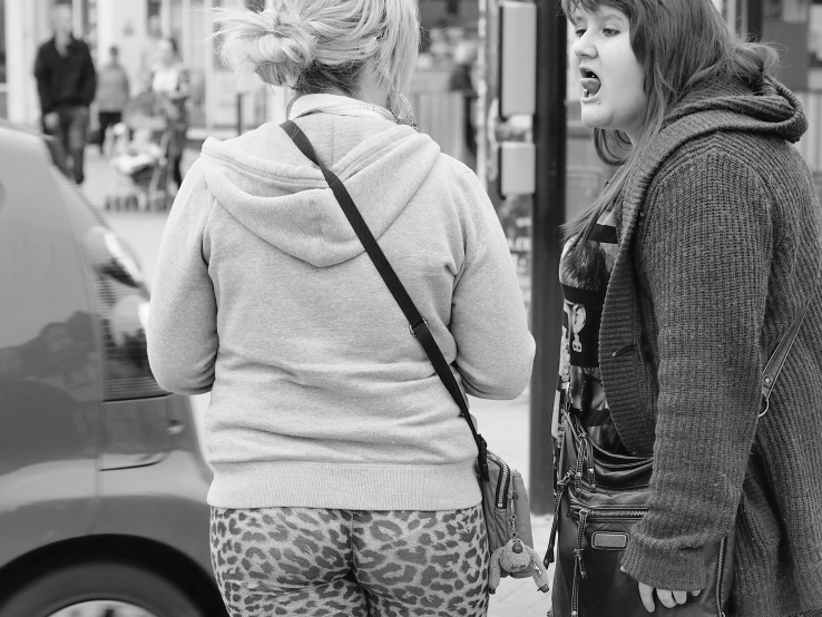 two women talking outside on the street