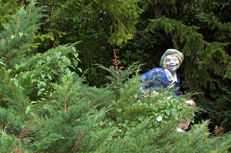 a sculpture of a woman with blue hair and a green suit