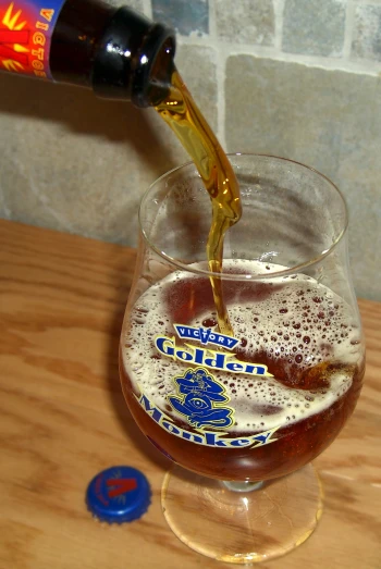 a glass of alcohol being poured into it