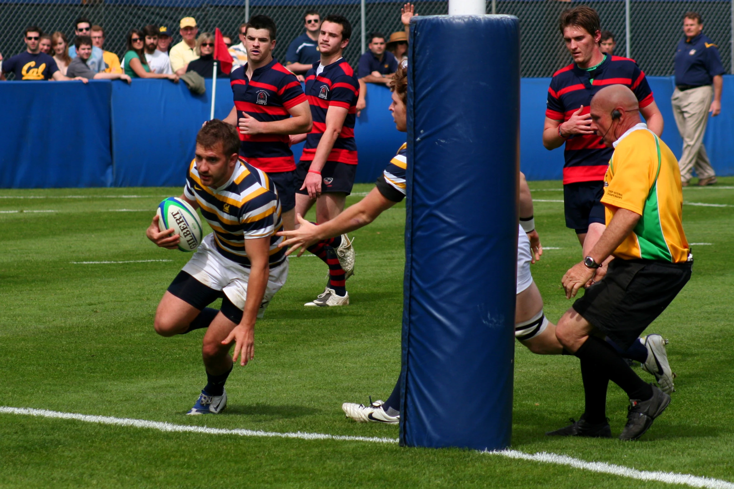 a group of men playing rugby on grass field