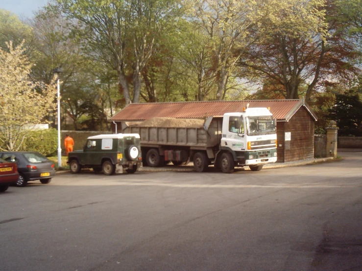 two trucks are parked in a lot