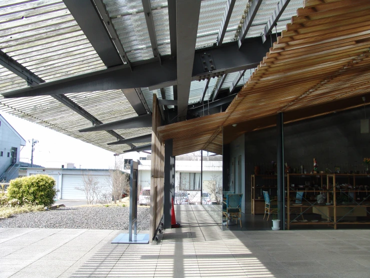 a wooden and glass building is shown with the sunlight beaming in