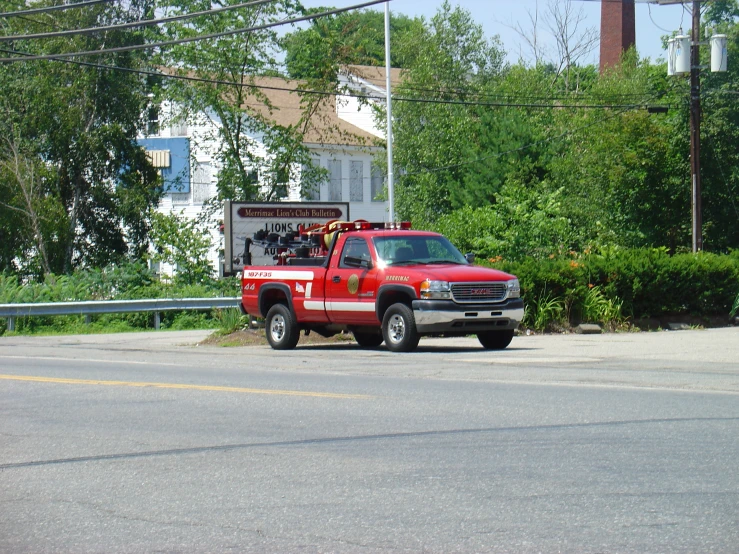 a red truck sits on a quiet street